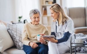 Female senior resident using digital patient care technology